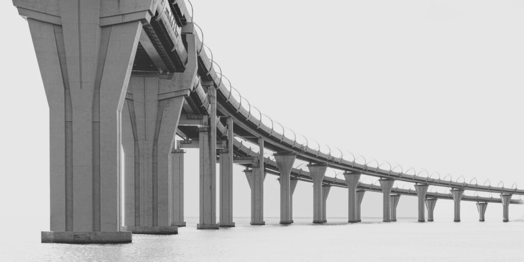 A black and white image of a bridge