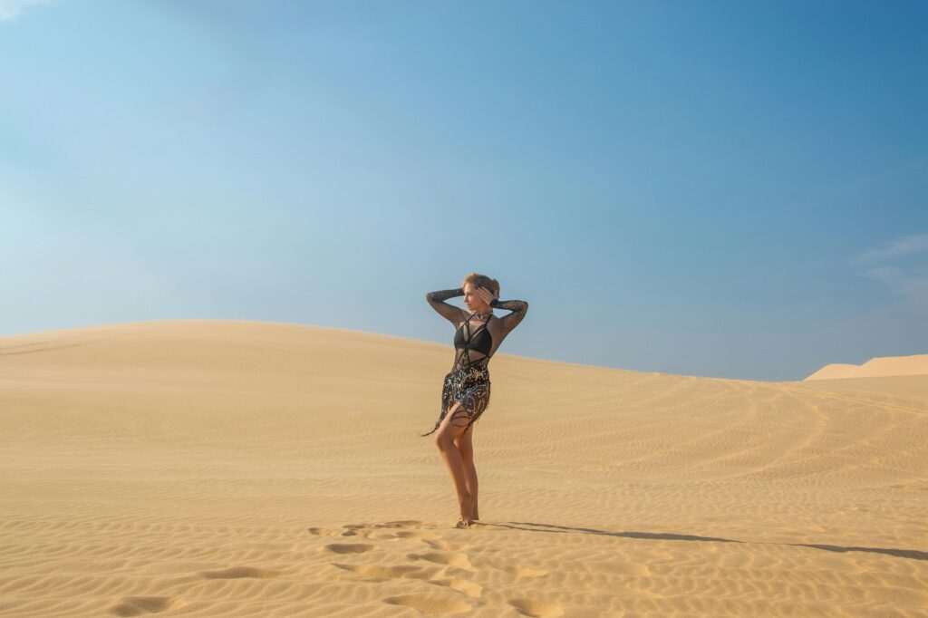 Woman in Stylish Dress Posing in Desert